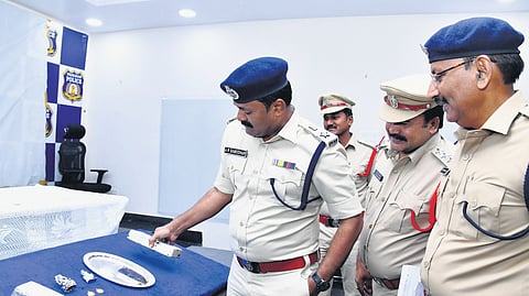 Prakasam SP AR Damodar inspecting the temple ornaments that were recovered from the thief on Monday