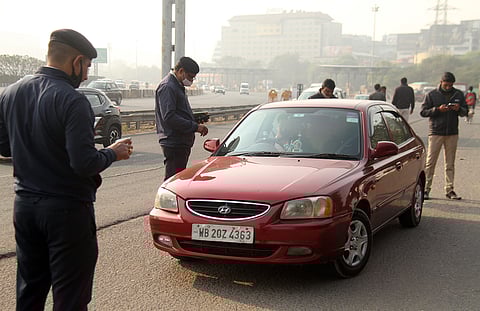 Delhi police personnel check vehicles at the Gurugram-Delhi border near Sirhaul toll plaza.