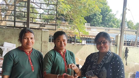 Naik (middle) handing the gold bracelet to its owner.
