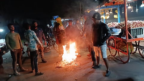 People gather around a bonfire at Rourkela on Sunday night.