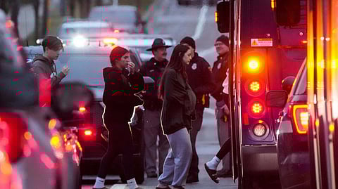 Students aboard a bus as they leave the shelter following a shooting at the Abundant Life Christian SchooL