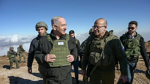 Israel's Prime Minister Benjamin Netanyahu, left, visits Israeli forces in a buffer zone inside Syria.