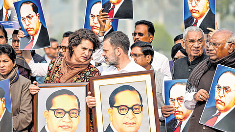 Opposition MPs hold portraits of BR Ambedkar during a protest in Parliament House Complex.