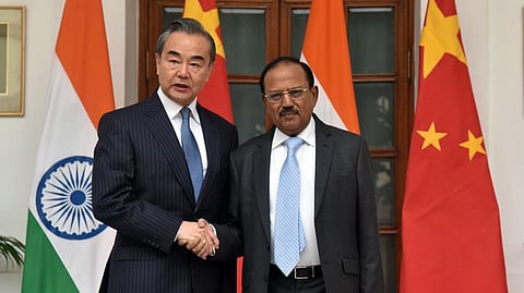 India's National Security Advisor (NSA) Ajit Doval (R) poses with China's Foreign Minister Wang Yi.