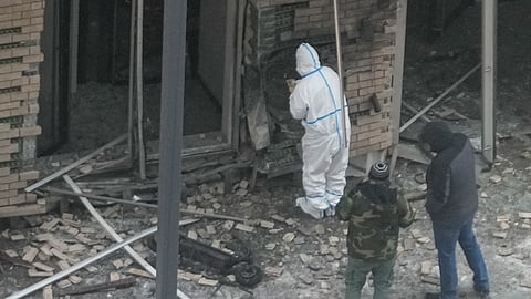 Investigators work near a scooter at the place where Lt. General Igor Kirillov, the head of Russia's Nuclear, Biological, and Chemical Defence Forces and his assistant Ilya Polikarpov were killed.