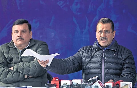 AAP National Convenor Arvind Kejriwal and Sanjay Singh during a press conference at the party office in New Delhi on Friday