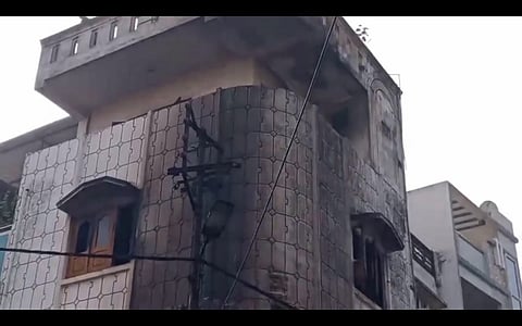 View of the milk parlour-cum-house after a fire that erupted here killed four members of a family, in Madhya Pradesh's Dewas,