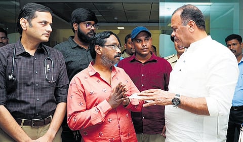 Cinematography Minister Komatireddy Venkat Reddy with the father of Sri Tej at KIMS in Hyderabad on Saturday