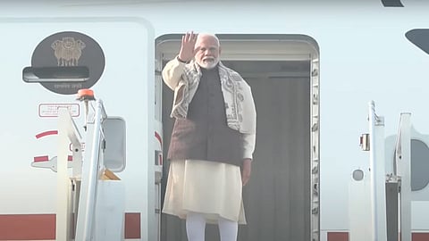 Prime Minister Narendra Modi waves as he emplanes for Kuwait on a two-day visit, in New Delhi.