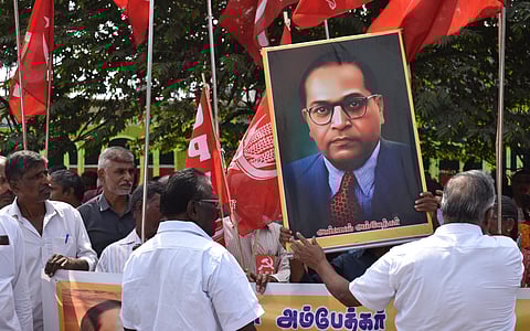 Members of CPI and CPM staged a protest by holding BR Ambedkars portrait, against Amit Shah for his alleged derogatory comments on BR Ambedkar at TATABAD in Coimbatore on Friday.