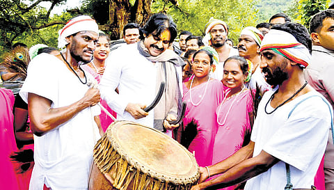 Deputy CM Pawan Kalyan beats a drum during his visit to Ballagaruvu village in ASR district on Saturday