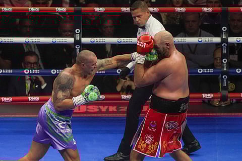 Boxers Britain's Tyson Fury, right, and Ukraine's Oleksandr Usyk compete during their WBA, WBO, and WBC world heavyweight title fight in Riyadh, Saudi Arabia, Saturday, Dec. 21, 2024.