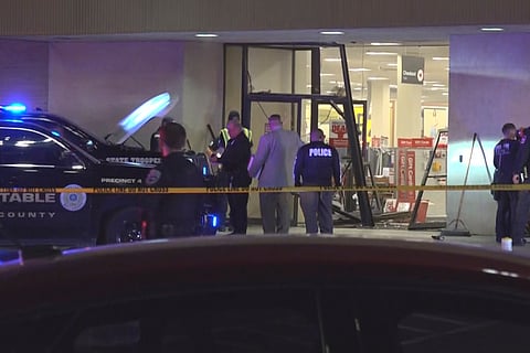 This image taken from video provided by KCEN-TV shows police responding after a man drove a vehicle into a JCPenney at a shopping mall Saturday