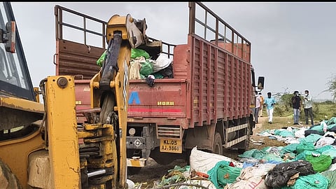 excavators began loading the waste onto trucks from Kerala