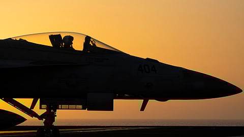 A fighter jet maneuvers on the deck of the USS Dwight D. Eisenhower in the Red Sea