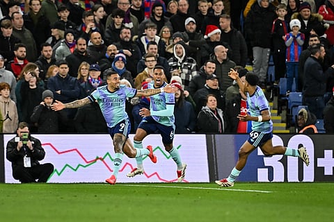 Arsenal's Brazilian striker Gabriel Jesus (L) celebrates with Arsenal's Brazilian defender Gabriel Magalhaes (C) and Arsenal's English midfielder Myles Lewis-Skelly after scoring his team first goal during the EPL football match between Crystal Palace and Arsenal