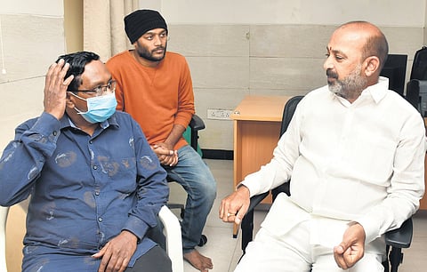 Union Minister of State for Home Affairs Bandi Sanjay Kumar interacts with father of Sri Tej at a hospital on Sunday