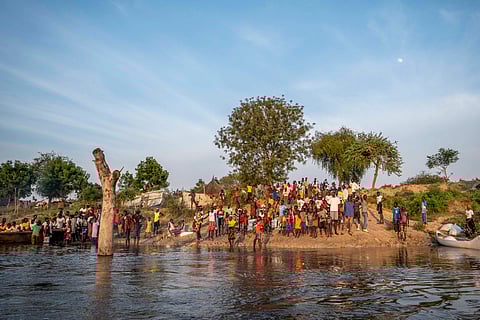 People gather along a flooded area in Jonglei state, South Sudan, Wednesday, Nov. 13, 2024.