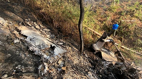 This handout photo released by Civil Protection of Jalisco state shows a man looking at the site where a Cessna 207 plane crashed in Santa Maria del Oro, Jalisco state, Mexico on December 22, 2024.