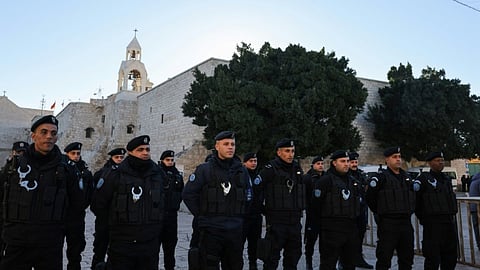 Palestinian policemen stand guard at Manger Square on Christmas eve outside Bethlehem's Church of the Nativity.