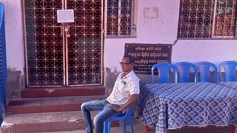 Jena sitting outside the locked grievance cell in Biridi block office