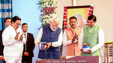 Prime Minister Narendra Modi with Union Minister C.R. Patil and Madhya Pradesh Chief Minister Mohan Yadav during the foundation stone-laying ceremony of the Ken-Betwa River Linking Project in Khajuraho, Madhya Pradesh, on Wednesday, Dec. 25, 2024.