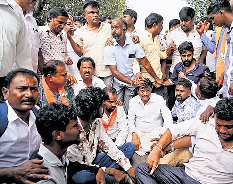 RR Nagar MLA Munirathna surrounded by his supporters soon after miscreants threw an egg at him in Bengaluru on Wednesday