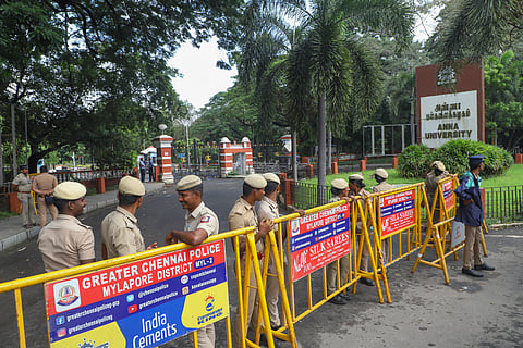 Police personnel stand guard outside the Anna University campus after the alleged sexual assault of a girl student