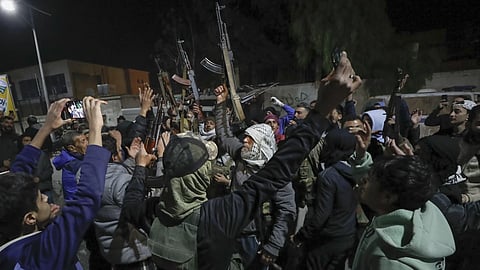 Syrian rebel fighters shout slogans against the late Assad regime in the Mazzeh district in Damascus, Wednesday, Dec 25, 2024.