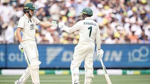 Australia's Sam Konstas (L) touches gloves with Australia's Usman Khawaja on day one of the fourth cricket Test match between Australia and India at the Melbourne Cricket Ground (MCG) in Melbourne.