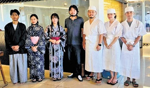 Takeo San (in centre) with his staff