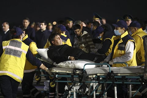 Wounded passengers of the Azerbaijani Airlines plane crash transported from a medical plane at the Heydar Aliyev International Airport outside Baku, Azerbaijan, Thursday, Dec 26, 2024.