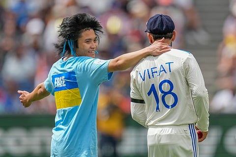 A pitch invader tried to hug Virat Kohli during play on the second day of the Test at the MCG (Photo | AP)