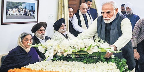 Prime Minister Narendra Modi pays his last respects to former prime minister Manmohan Singh, in New Delhi on Friday | PTI