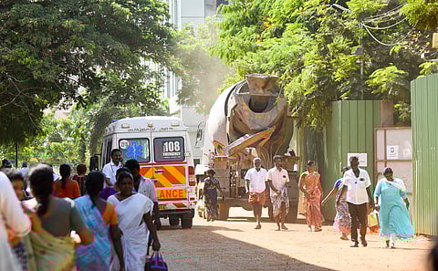 Visitors at MGMGH walk through a cloud of dust on Friday