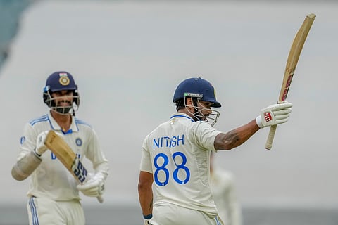 India's Nitish Kumar Reddy, right, celebrates his fifty runs during play on the third day of the fourth cricket test between Australia and India at the Melbourne Cricket Ground, Melbourne, Australia, Saturday, Dec. 28, 2024.