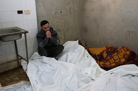 A Palestinian man sits mourning relatives killed in overnight Israeli airstrikes on the Maghazi refugee camp, at Al-Aqsa Hospital, in Deir al-Balah, central Gaza Strip, Saturday, Dec. 28, 2024.