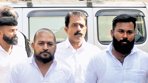 Accused persons after the verdict in Kochi on Saturday (right) former CPM MLA K V Kunhiraman