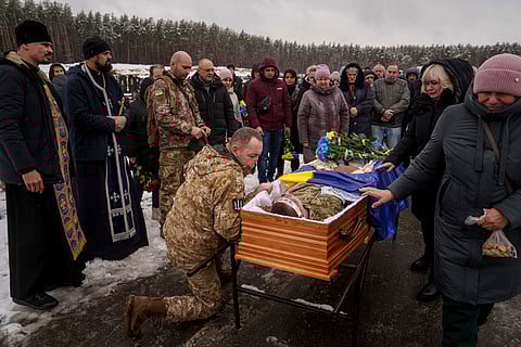 During a funeral ceremony in Irpin, the Kyiv region of Ukraine, on Nov. 21, serviceman Roman bids farewell to a comrade from the 47th Brigade -- Serhii Solovyov -- who was killed during fighting with Russian Forces in Kursk on November 12, 2024.