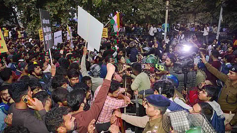 Security personnel try to stop aspirants during a protest against the BPSC 70th Integrated Combined Competitive Examination (BPSC), demanding re-examination, in Patna on Dec. 29.