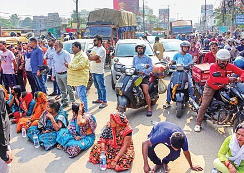 Locals staging road blockade at Laxmisagar Square on Sunday afternoon