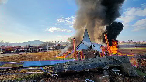 Fire and smoke rise from the tail section of a Jeju Air Boeing 737-800 series aircraft after the plane crashed and burst into flames at Muan International Airport in South Jeolla Province, some 288 kilometres southwest of Seoul on December 29, 2024
