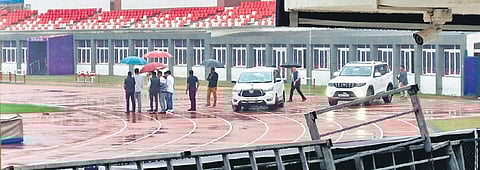 Two vehicles parked on the athletics track of the Kalinga Stadium
