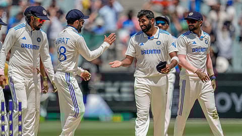 India's Jasprit Bumrah, second right without cap, celebrates with teammates after the dismissal of Australia's Alex Carey during play on the day four of the fourth cricket test between Australia and India at the Melbourne Cricket Ground, Melbourne.