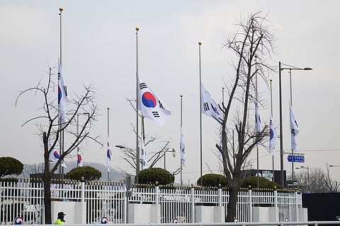 South Korean national flags fly at half-staff at a government complex in Seoul, South Korea.