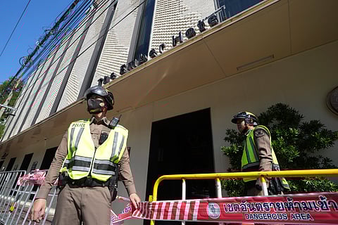 Police forensics team arrive at a hotel in Bangkok, Thailand, Monday, Dec. 30, 2024 after a fire.