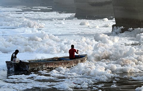 File | Workers spray chemicals to dissolve toxic foam in the polluted Yamuna river at Kalindi Kunj during 'Chhath'' festival, in New Delhi, 2024.