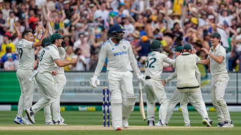 Australian players celebrates the wicket of Jasprit Bumrah during play on the last day of the fourth cricket test between Australia and India at the Melbourne Cricket Ground.