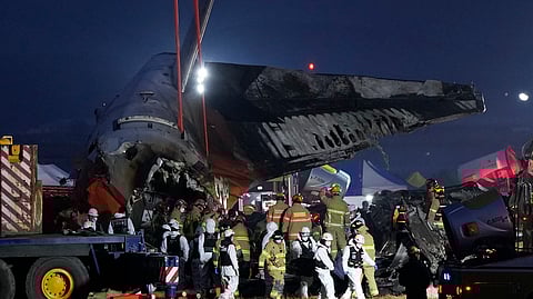 Rescue team carry the body of a passenger at the site of a plane fire at Muan International Airport in Muan, South Korea.