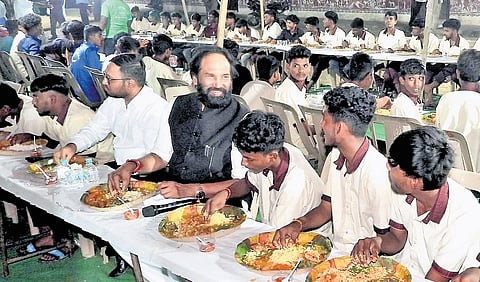 Irrigation & Civil Supplies Minister N Uttam Kumar Reddy shares a light moment with the students of SC Residential School at Chilukuru in Suryapet on Tuesday